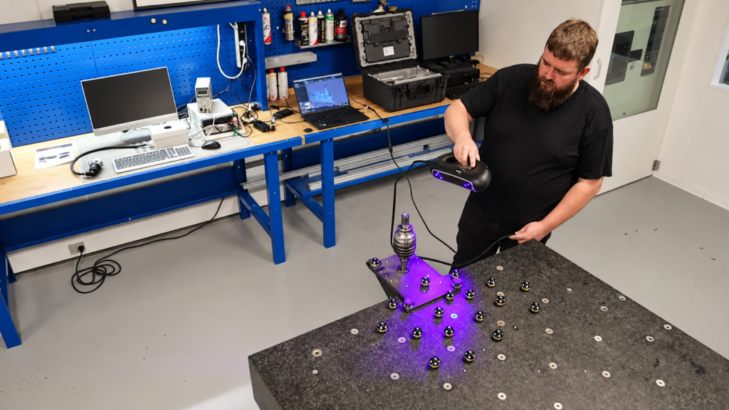 Medarbejder hos Triscan scanner en komponent med Creaform HandySCAN PRO som del af virksomhedens kvalitetskontrol.